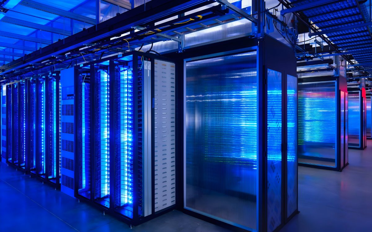 Rows of illuminated blue server racks inside a modern data centre
