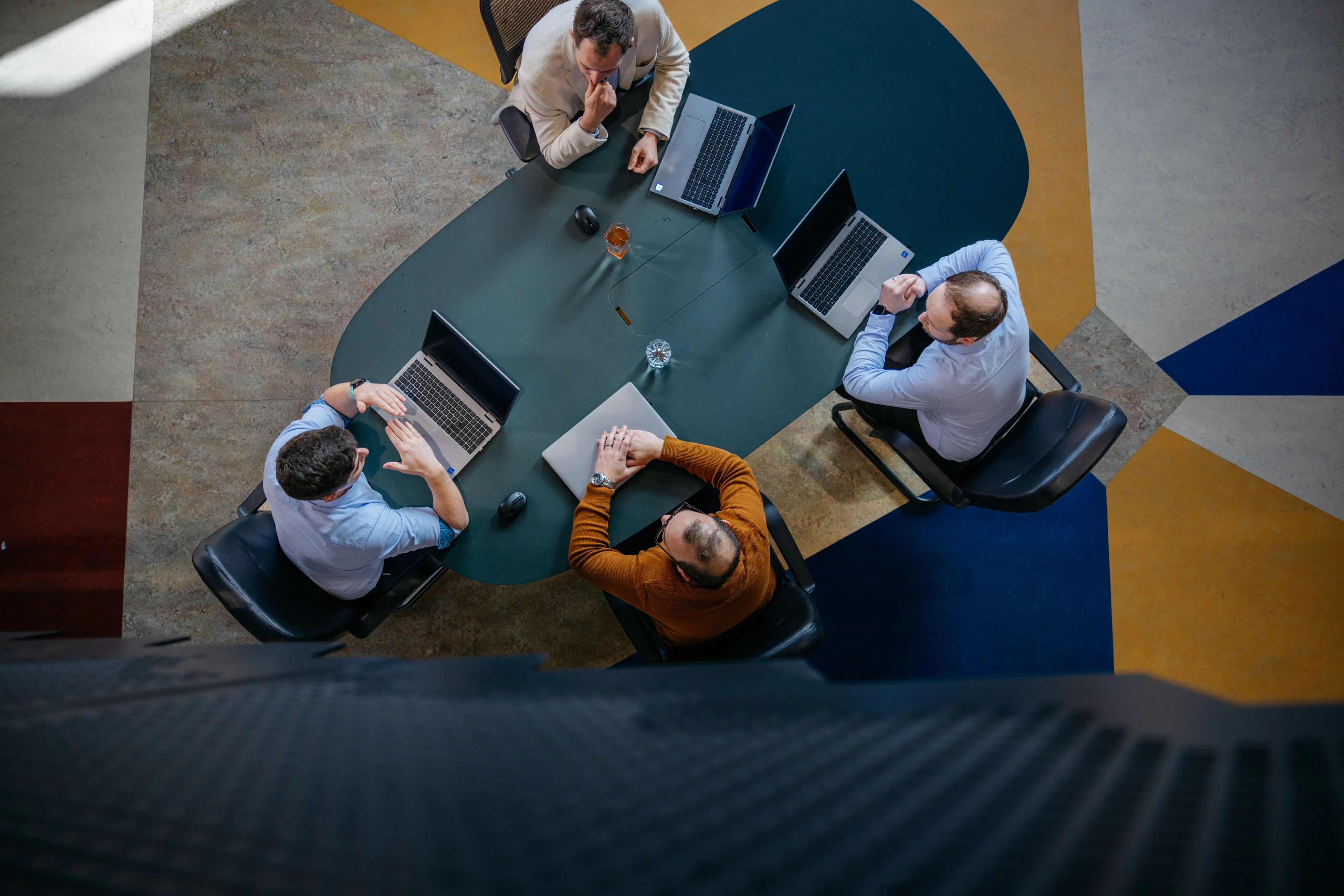 EM3 team in a meeting room around a conference table