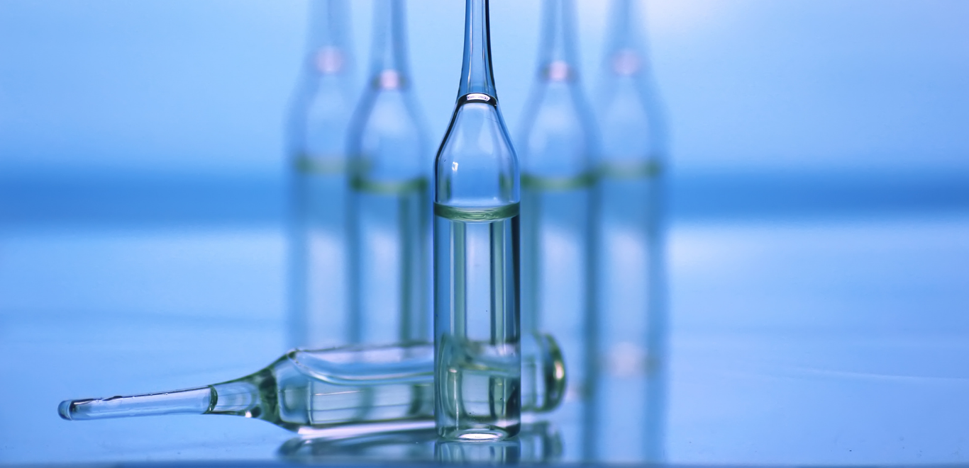 Glass WFI vials against dark blue