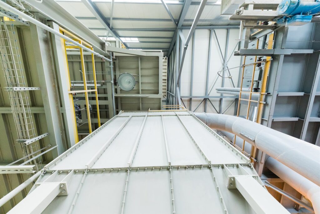Interior of a modern operational industrial plant with pipework and access ladders