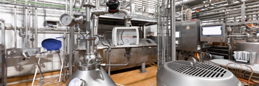 Close-up of industrial pipework, wiring and instrumentation on an ageing asset