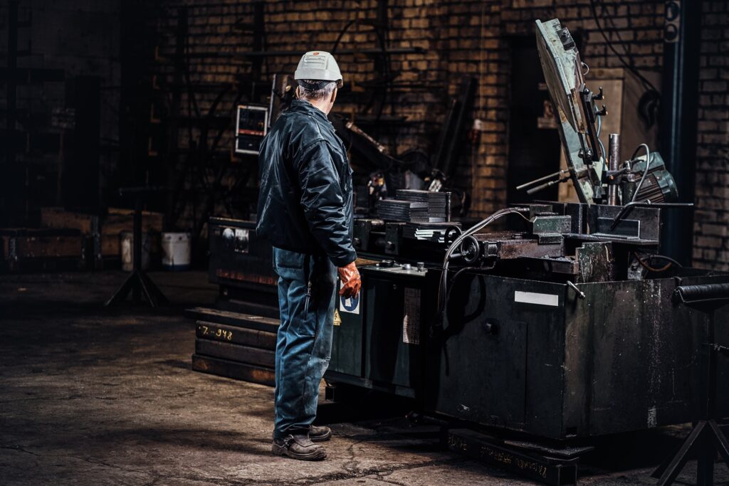 Engineer working with industrial equipment on a factory floor