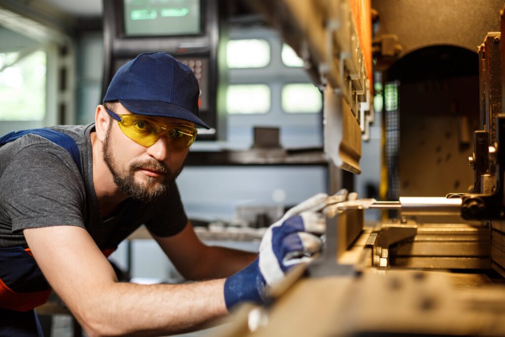 EM3 engineer beside industrial machinery on the plant floor
