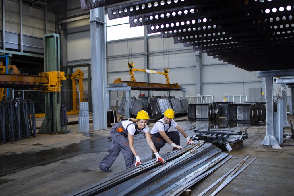 Factory workers in protective equipment coordinating on an industrial installation