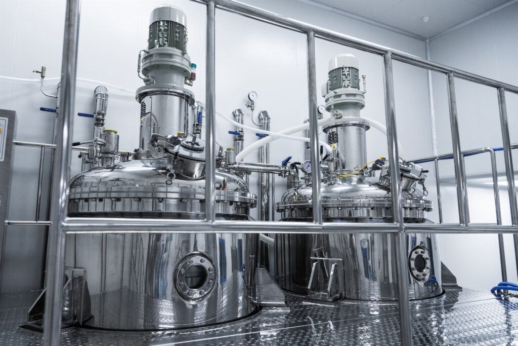 A clean, commissioned process plant with stainless reactor vessels and instrumentation
