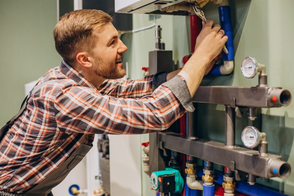 EM3 engineer adjusting and diagnosing an industrial heating system on site