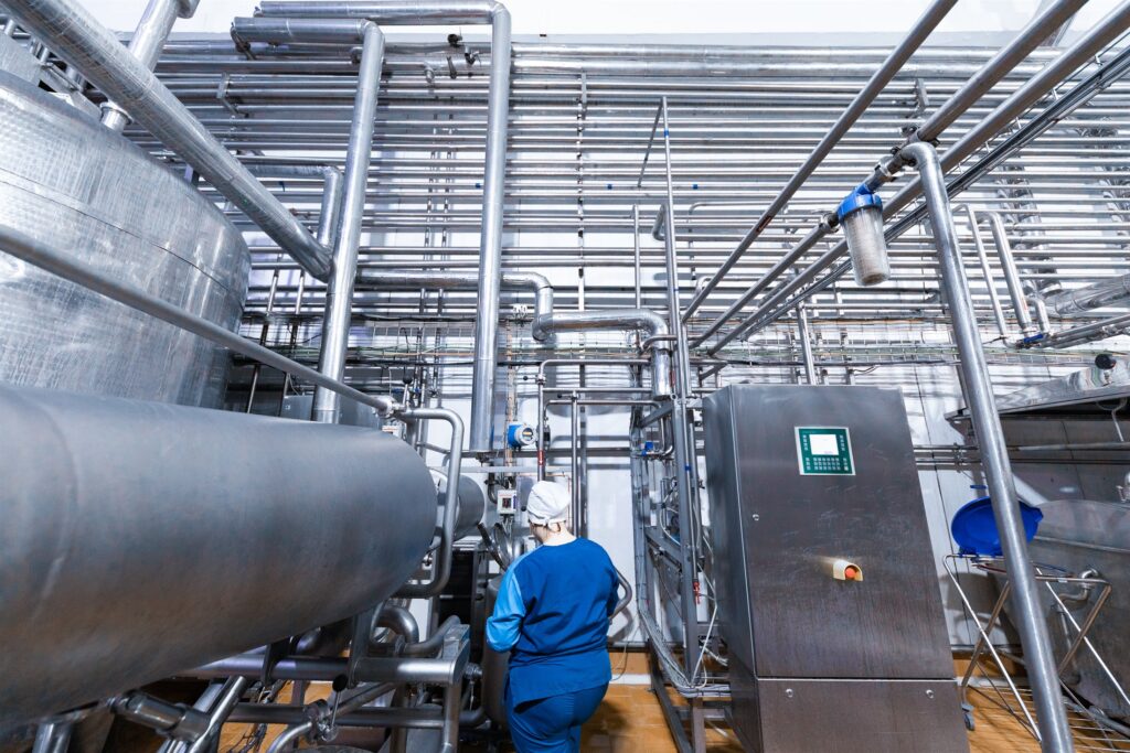 EM3 engineer working at process equipment on an industrial site