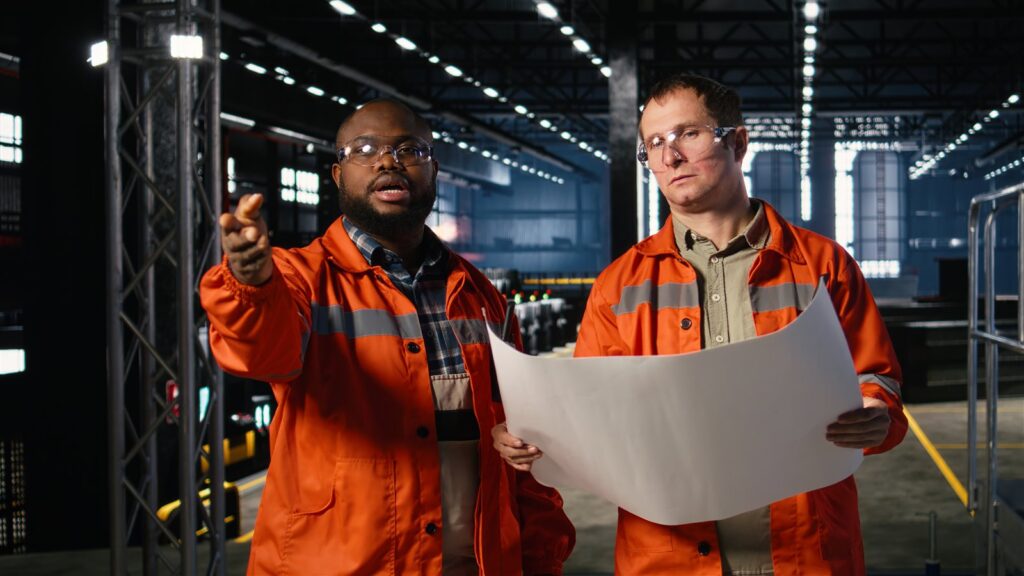Two EM3 engineers reviewing a site assessment in an industrial facility