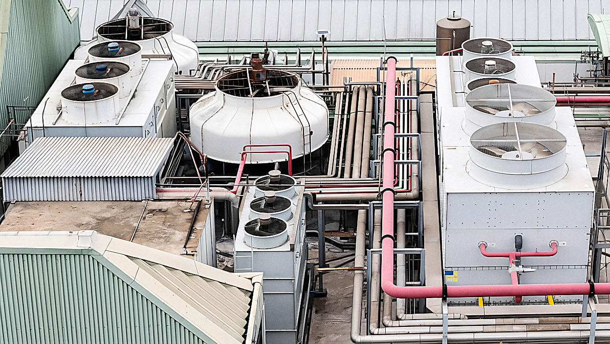 An industrial cooling tower system on a plant rooftop