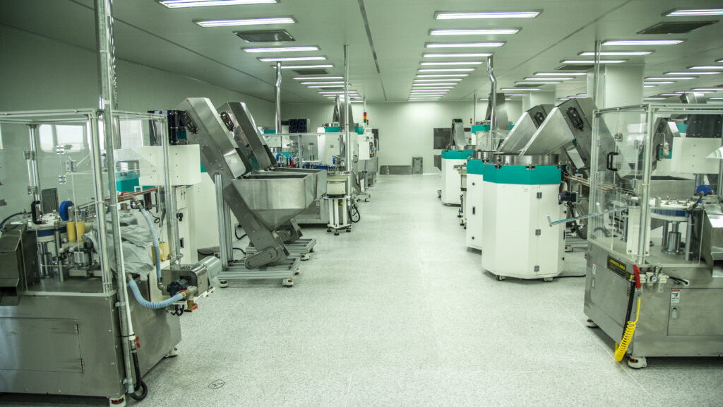 Laboratory analysts working at instruments in a bright modern medical laboratory