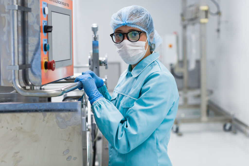 Operator at a control panel during an on-site assessment in a pharmaceutical production area